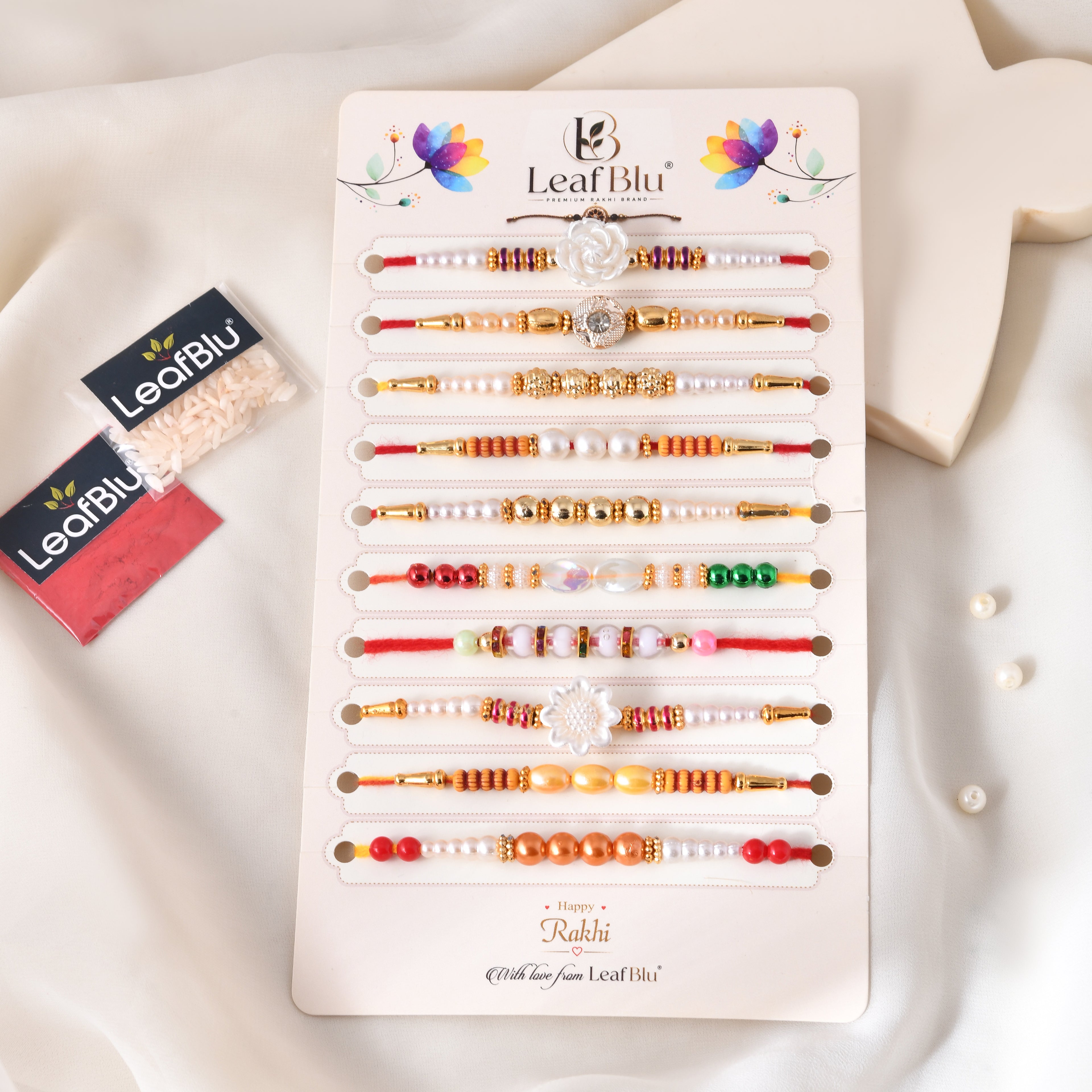 LeafBlu Premium Designer Rakhi Set of 10 for Brother with Rakhi Agreement Card, Greeting Card & Roli Chawal | Handmade Pearl & Floral Raksha Bandhan Gift Combo
