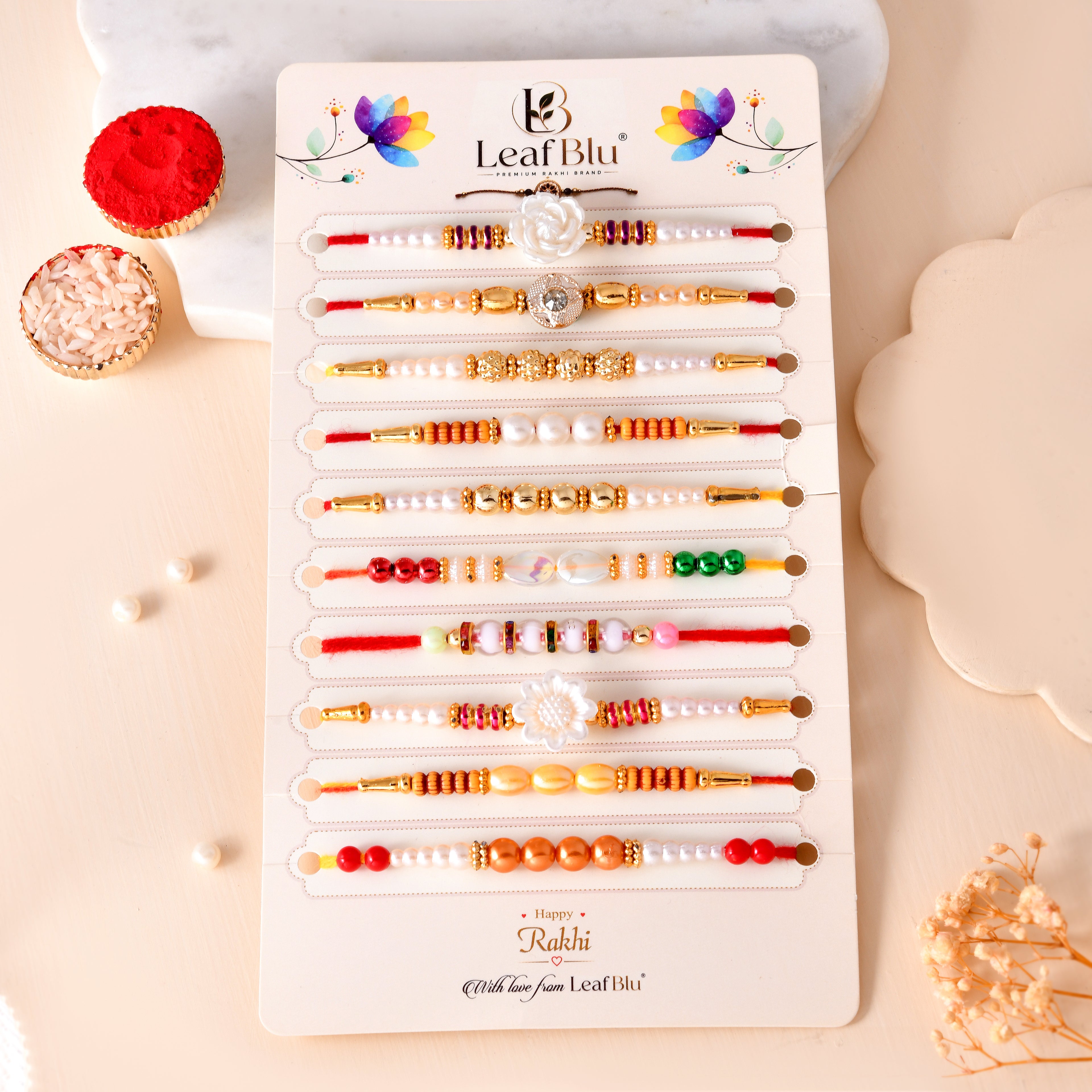 LeafBlu Premium Designer Rakhi Set of 10 for Brother with Rakhi Agreement Card, Greeting Card & Roli Chawal | Handmade Pearl & Floral Raksha Bandhan Gift Combo