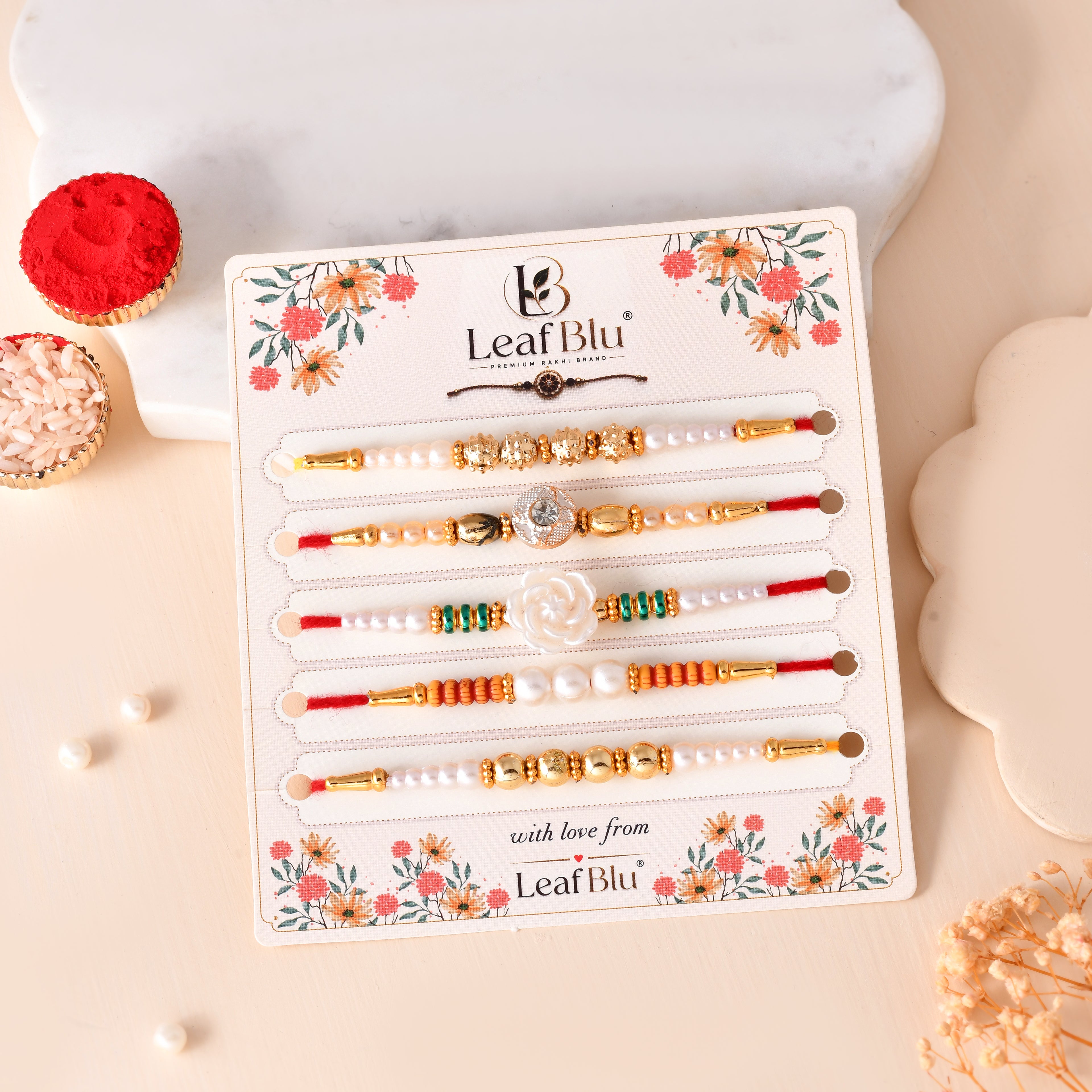 LeafBlu Premium Designer Pearl & Crystal Rakhi Set of 5 for Brother with Rakhi Agreement Card, Greeting Card & Roli Chawal | Handmade Raksha Bandhan Gift Pack